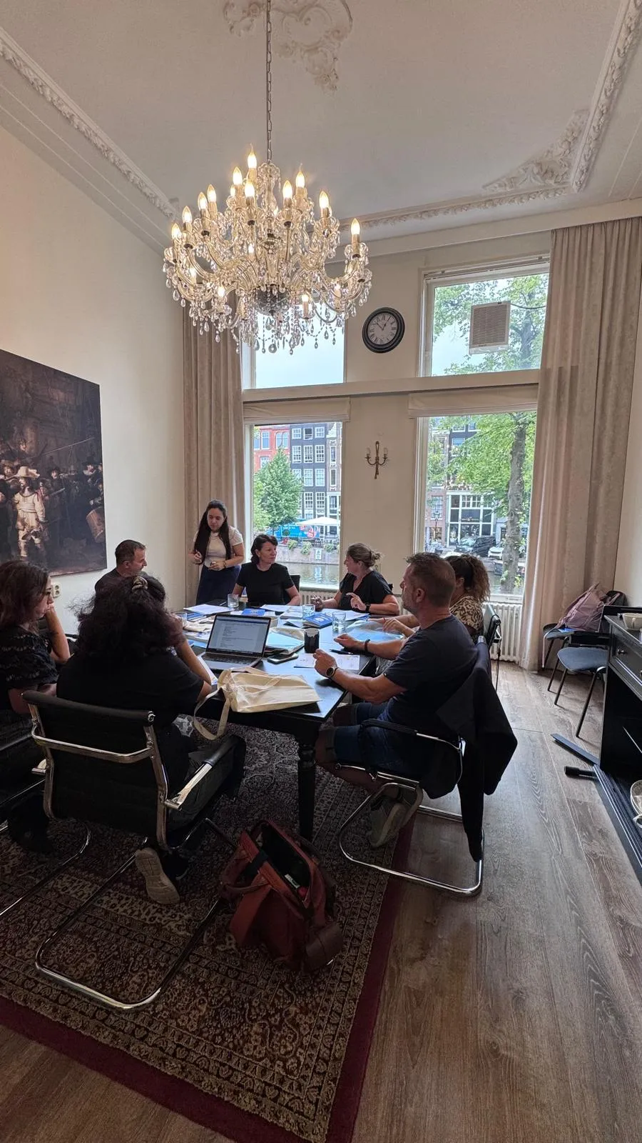 International educators exchanging ideas during an English course beside an Amsterdam canal