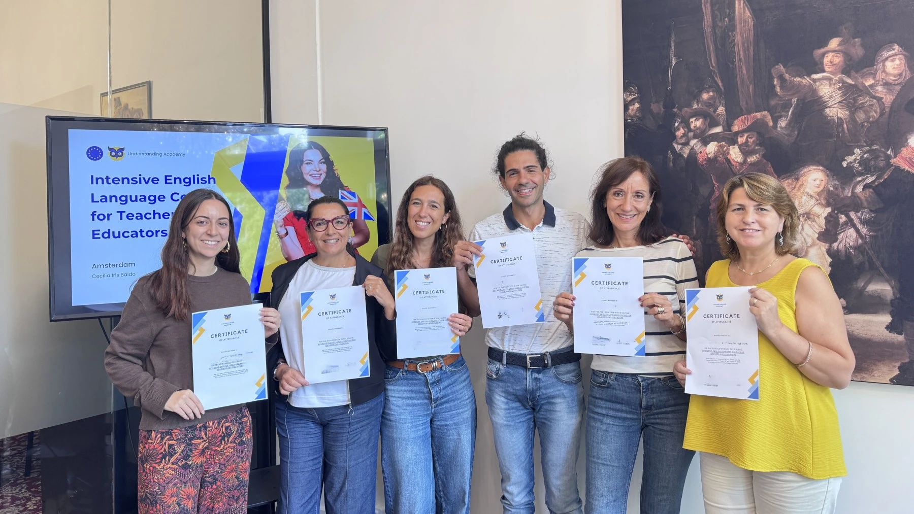 Understanding Academy course participants holding their certificates