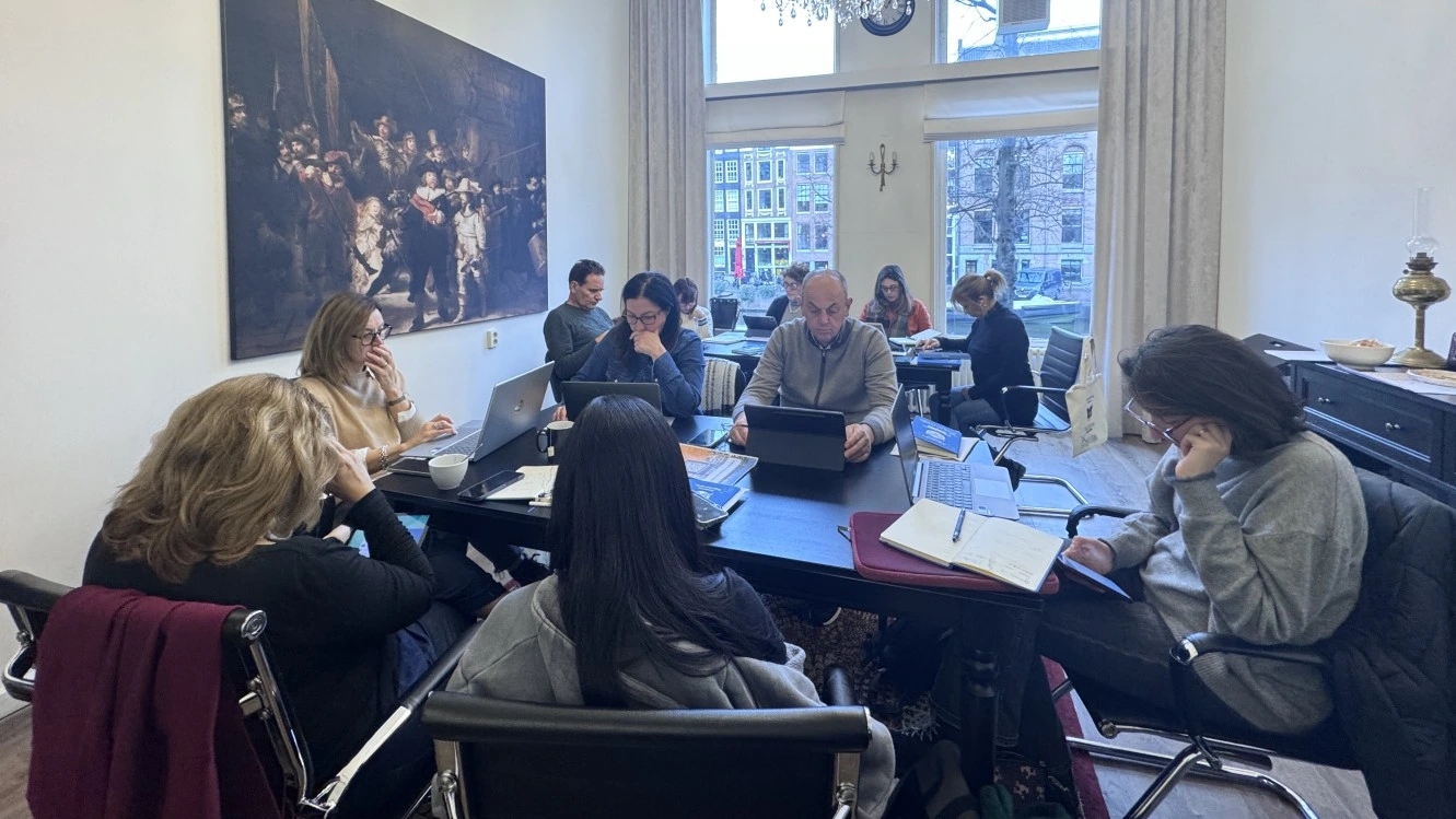 Educators working with laptops during a teacher training course